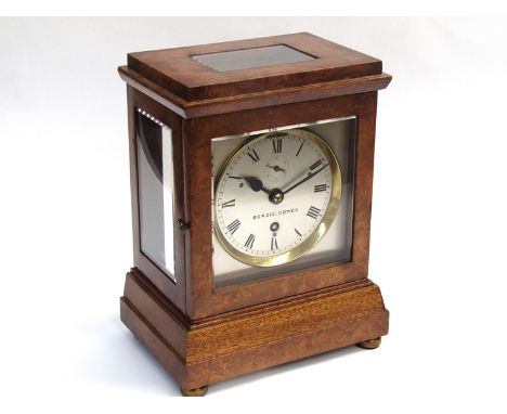 A 20th Century burr walnut veneered bracket clock with five bevelled glass panels, front and rear doors, silvered Roman dial 