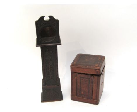 A carved wooden pocket watch holder in the form of a longcase clock (34cm high), together with a leather carriage clock box (