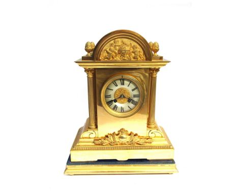 A late 19th Century French gilt brass cased arched top mantel clock of architectural form with egg and dart front stepped bor