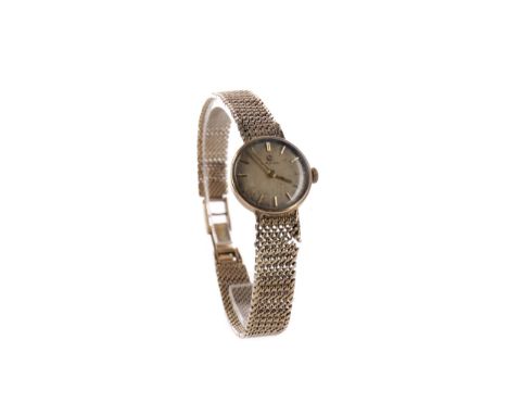LADY'S OMEGA NINE CARAT GOLD MANUAL WIND WRIST WATCH, the round cream dial with applied baton hour markers, 18mm case, on an 