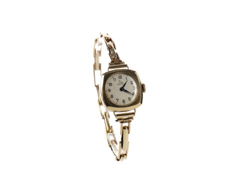 LADY'S RECORD NINE CARAT GOLD MANUAL WIND WRIST WATCH, the round silver and cream coloured dial with Arabic hour markers, out