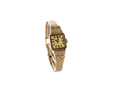 LADY'S ACCURIST NINE CARAT GOLD MANUAL WIND WRIST WATCH, the cushion shaped dial with applied baton hour markers, 14mm case, 