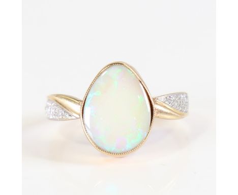 A modern 9ct gold opal and diamond dress ring, set with pear cabochon opal and eight cut diamond shoulders, total diamond con