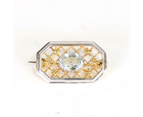 A late 20th century 9ct white and yellow gold aquamarine brooch, octagonal form with openwork lattice and floral decoration s