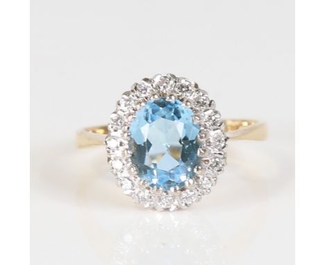 A late 20th century 18ct gold aquamarine and diamond cluster ring, set with oval mixed cut aqua and round brilliant cut diamo