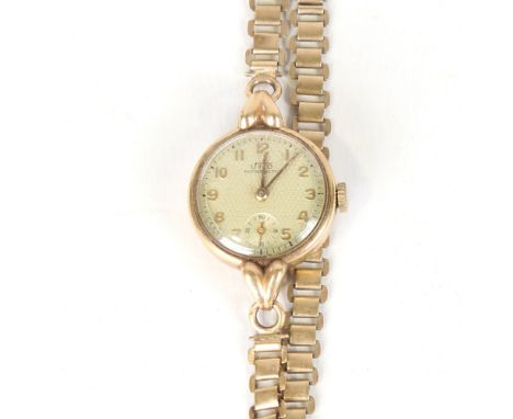 A lady's Vintage 9ct gold Uno mechanical wristwatch, textured silvered dial with gilt Arabic numerals and subsidiary seconds 