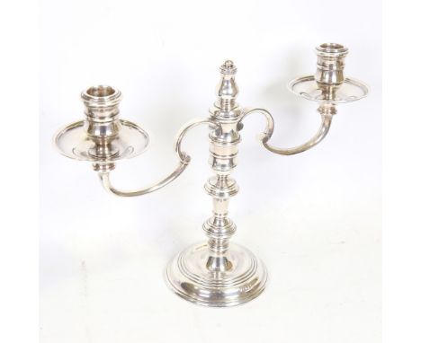 An Elizabeth II silver three-light candelabra, in Queen Anne style, with removable fitting to convert to single candlestick, 