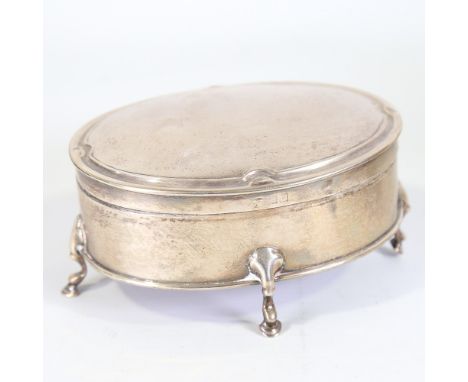 An Edwardian silver dressing table jewel box, oval form on hoof feet, by Goldsmiths and Silversmiths Co Ltd, hallmarks London