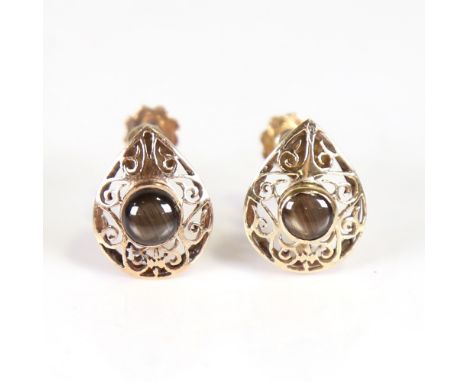 A Vintage pair of Continental 18ct gold cabochon star sapphire earrings, pierced scrollwork teardrop design with screw-back f