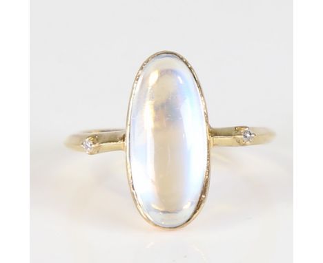 A modern 9ct gold blue moonstone and diamond dress ring, set with long cabochon moonstone and eight-cut diamond accents, sett