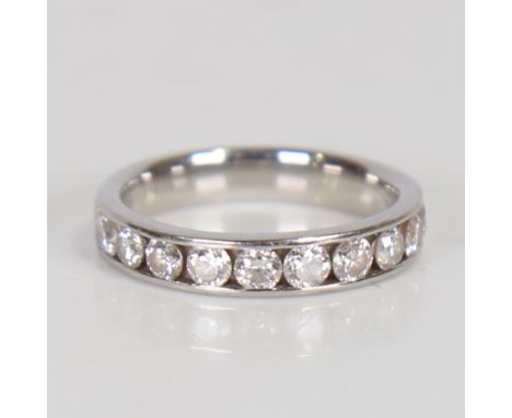 A modern platinum diamond half eternity ring, set with 10 modern round brilliant-cut channel set diamonds, total diamond cont