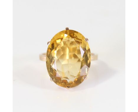 A large late 20th century citrine dress ring, unmarked gold set with large oval mixed cut citrine, setting height 21.3mm, siz