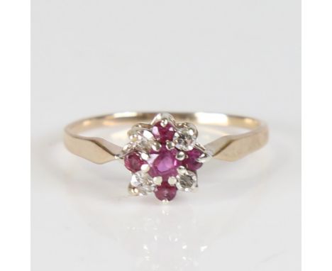 A late 20th century 9ct gold ruby and diamond snowflake ring, set with round cut stones, total diamond content approx 0.2ct, 