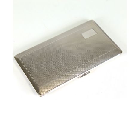 A large Elizabeth II silver cigarette case, allover engine turned decoration with gilt interior, by Harman Brothers, hallmark