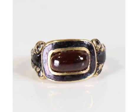 A Georgian 18ct gold garnet and black enamel mourning ring, set with oval cabochon garnet with foil back within a black ename