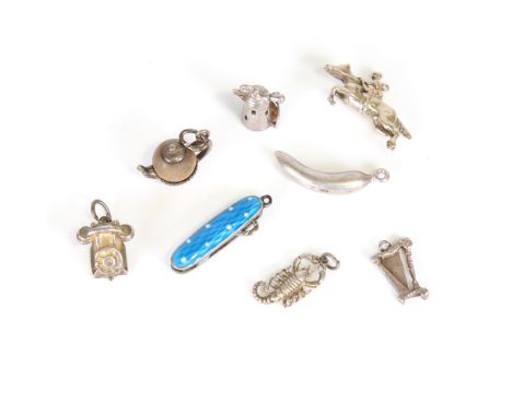 Various silver and white metal charms, including miniature enamel button hook, jockey, banana, lighthouse, etc, 19.1g total (