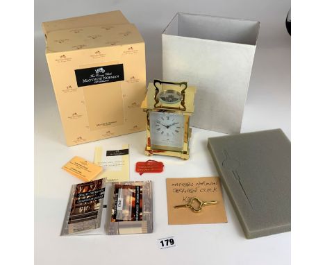 Boxed Matthew Norman brass carriage clock with key, instructions and receipt from 1979. 6” high. 