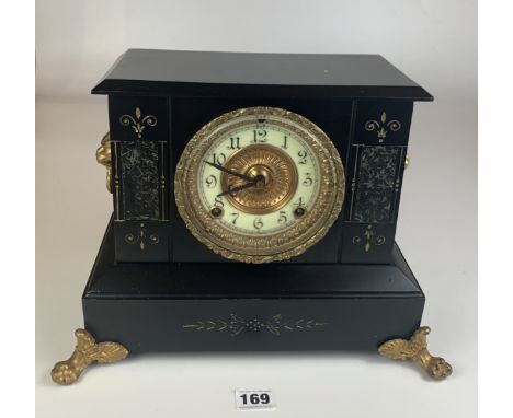 Black marble and gilt 2 hole mantle clock with ormolu mounts and white dial with gilt surround. 13” long x 10” high. With pen