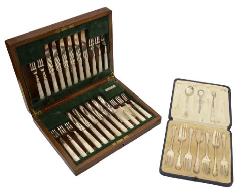 A George V cased silver Dubarry pattern set of six cake forks and server and a oak cased set of twelve mother of pearl handle