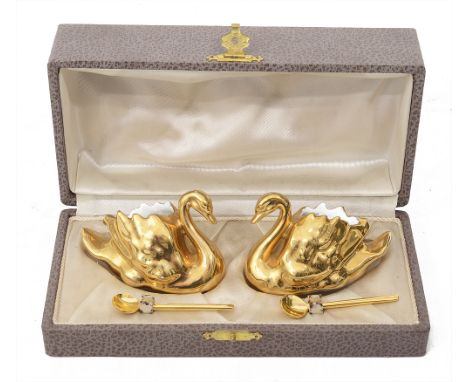 A pair of vintage French ceramic salts in the form of swanscased, in gold lustre finish, with spoons, marked to base G.S.L. F