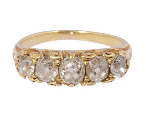 A Victorian five stone diamond ring, set with a graduated line of oval old brilliant-cut diamonds, to the yellow gold scrolli