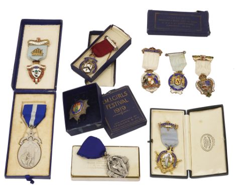 A small collection of early 20th century mostly enamelled silver Masonic jewelscomprising a cased silver gilt Cerepania Lodge