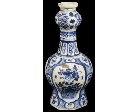 An 18th century Dutch Delft pottery garlic neck bottle vaseof hexagonal baluster form, decorated in underglaze blue with pane