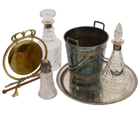 A collection of items to include two silver mounted crystal decanters, a electroplated champagne bucket and an Edwardian bras