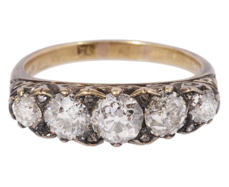 A late Victorian diamond five stone ring, the graduated line of old brilliant-cut diamonds with diamond points between, set w