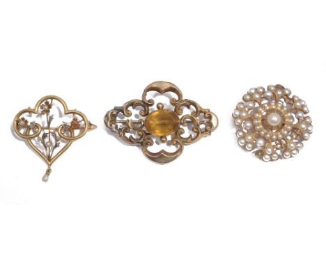 Three late Victorian/early 20th century yellow gold broochesthe first centrally collet-set citrine within a hollow openwork q