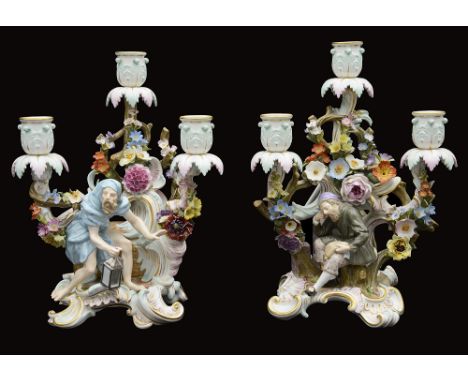A pair of late 19th century Meissen figural three light candelabra one modelled as Diogenes seated on an empty barrel holding