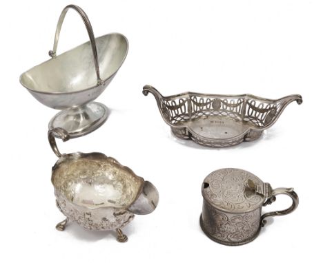 An early George III silver foliate embossed cream boat, an early Victorian mustard pot an Edwardian swing handled pedestal su