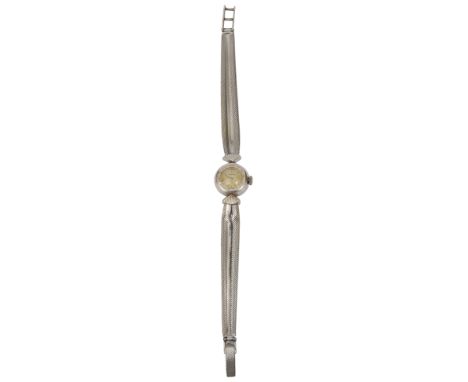 A ladies Omega white gold cocktail watch the circular dial with baton numerals with bright cut bezel, with engine turned stra