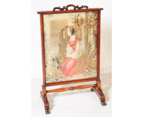 A 19th century Victorian rosewood tapestry firescreen. The screen raised on block feet, joined by a turned bobbin stretcher. 