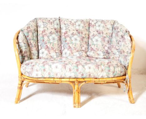 A mid 20th century bamboo and wicker conservatory sofa settee. The sofa having a bent cane bamboo frame, with woven crosshatc
