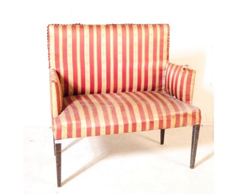 An early 20th Century Edwardian two seater salon settee / loveseat sofa of rectangular form with arm rests. Having upholstere