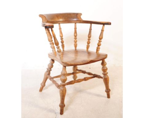 A 19th century Victorian beech and elm wood smokers bow armchair. The chair having a saddle seat raised on turned supports, u