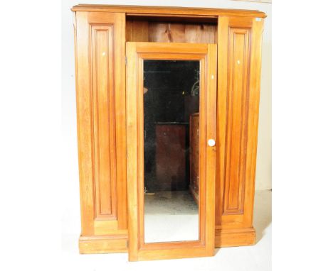 A 19th century Victorian pine wardrobe. The wardrobe having pediment to top over central mirrored door with ceramic knob hand