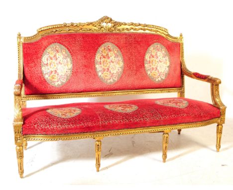 A 19th century Louis XV French giltwood three seater canape salon sofa settee. The canape having ornate giltwood frame with c