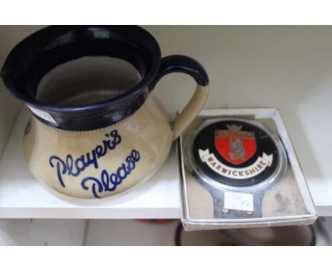 A Langley Ware pottery bar top water jug "Players Please" together with a "Warwickshire" car bumper badge (2)&nbsp;