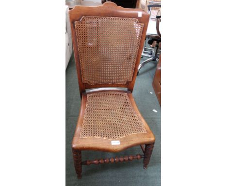 An Edwardian bedroom chair, bergere seat &amp; back, bobbin turned front legs &amp; stretcher