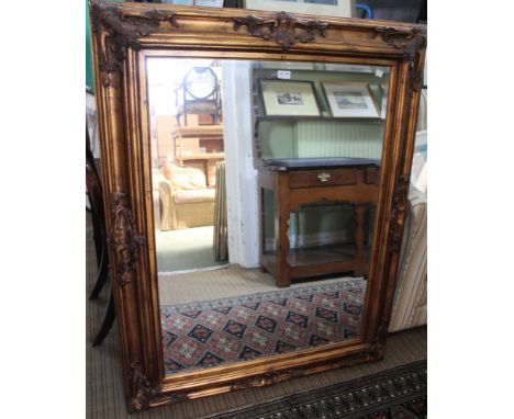 A large gilt framed bevel plated wall mirror