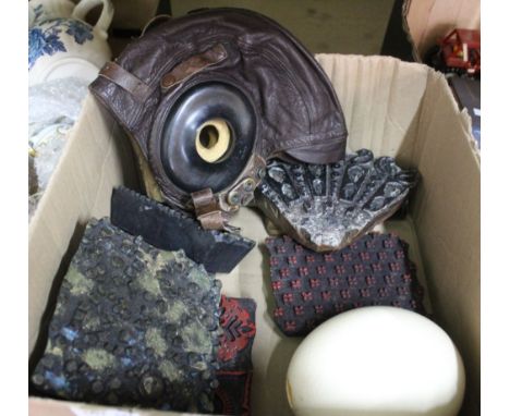 A Swan Shoe Company leather flying helmet, Indian textile printing blocks, a large bullet and an ostrich egg