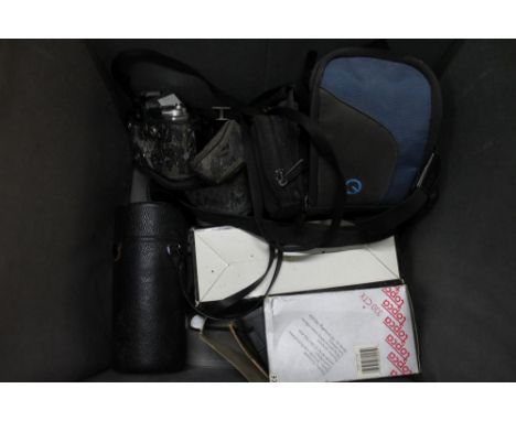 A Pentax MX 35mm SLR film camera with assorted lenses and accessories