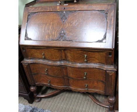 A reproduction oak bureau, with varied decoration &amp; swags