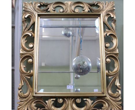 A bevel plate wall mirror with decorative gilt frame