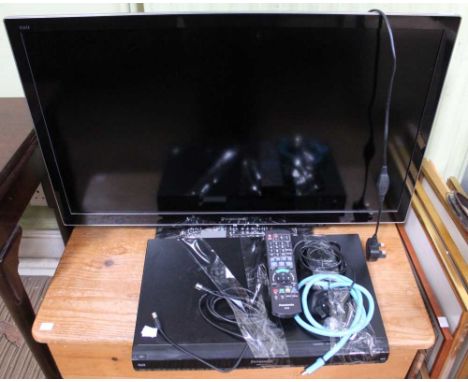 A Panasonic TV together with DVD, together with remotes