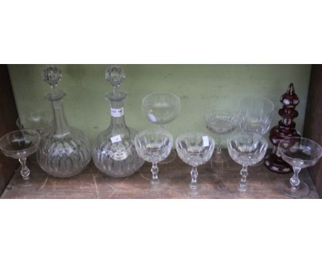 A pair of cut glass decanters with stoppers, one with a silver "Sherry" label, together with a variety of champagne and other
