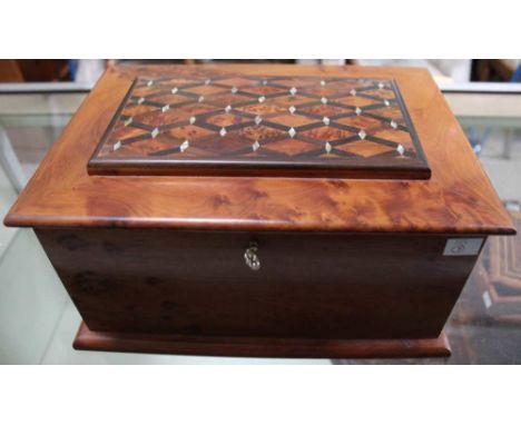 A burr wood jewellery casket, the hinged lid parquetry inlaid with mother of pearl, opens to reveal inner compartment and mir