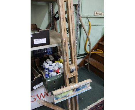 A studio easel and a quantity of artists paints